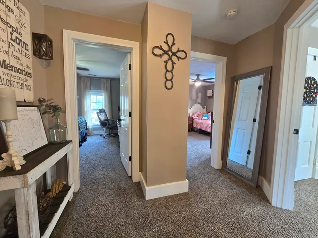 a view of a hallway view with staircase and living room