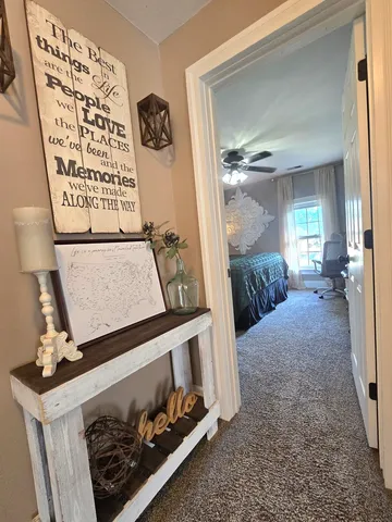 a bedroom with a bed and a flat tv screen on dresser