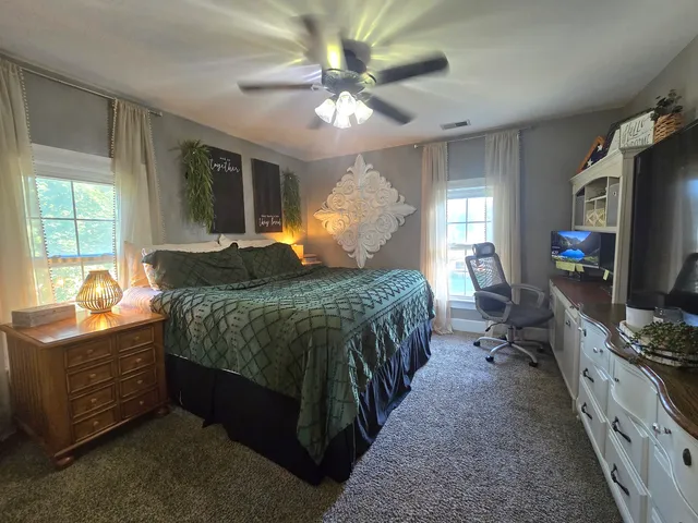 a bedroom with a bed and a large mirror