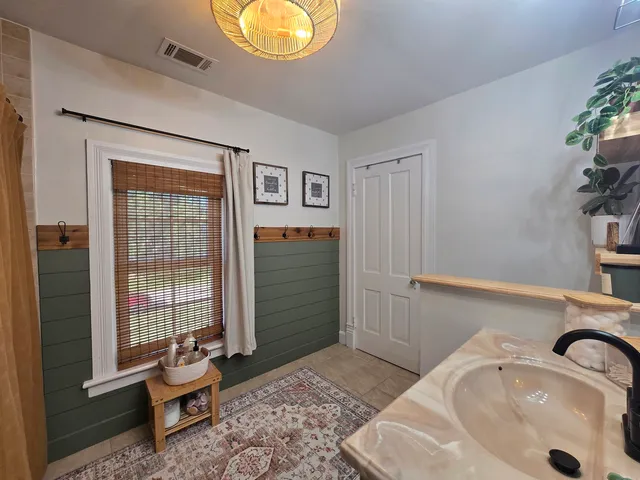 a bathroom with a bathtub and shower