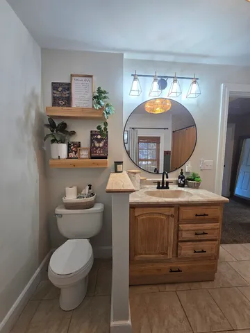 a bathroom with a toilet a sink and a mirror