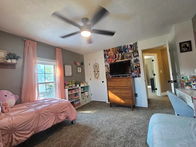 a bedroom with furniture and a mirror