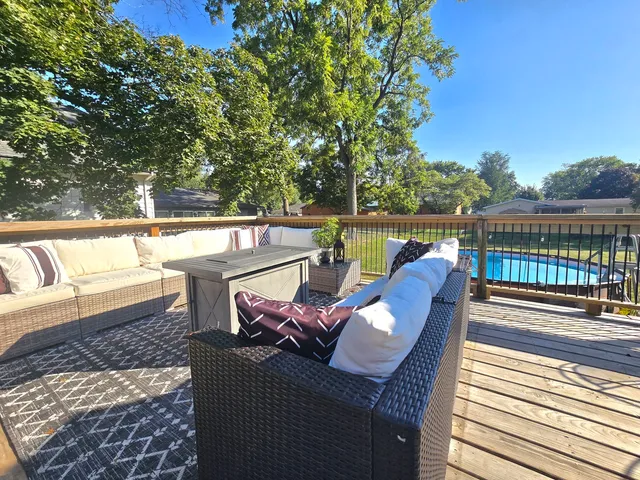 a view of balcony with furniture and umbrella