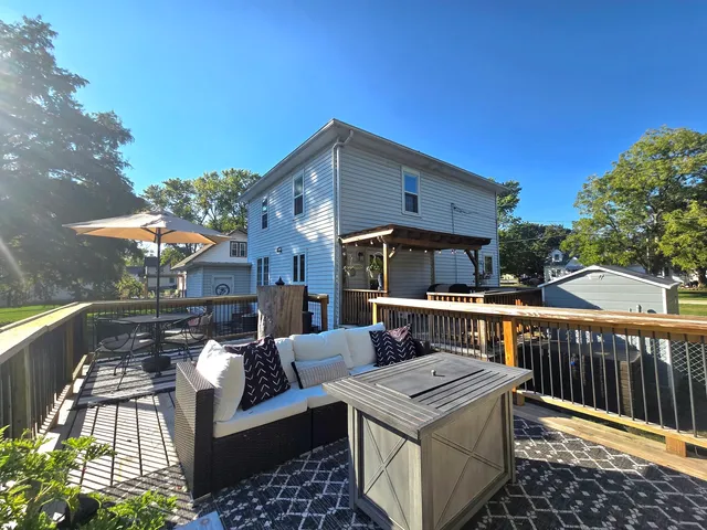 a view of a swimming pool with a yard and plants