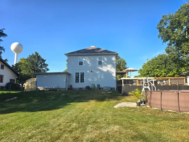 a view of a house with a yard and furniture