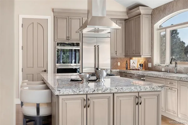 a kitchen with granite countertop a sink stove and cabinets