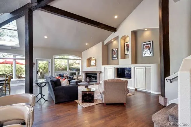 a living room with fireplace furniture and a large window