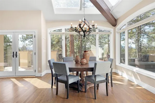 a view of a dining room with furniture wooden floor and chandelier