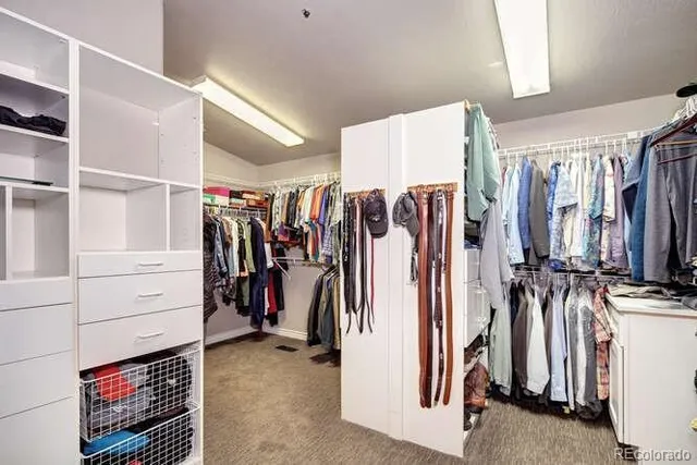 a view of walk in closet with clothes