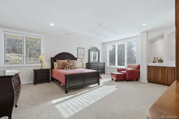 a bedroom with a large bed and a window