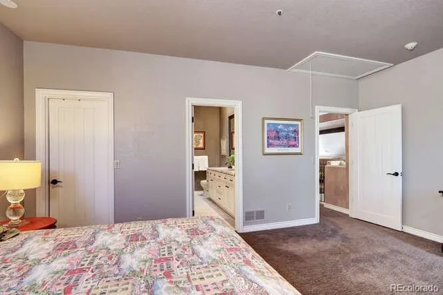 a bedroom with a bed and a lamp