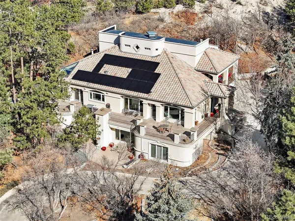 an aerial view of a house with a yard and balcony