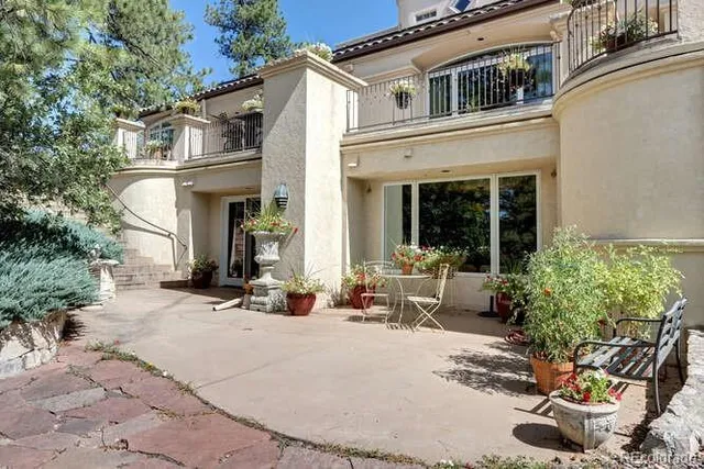 a view of a house with sitting area and potted plants