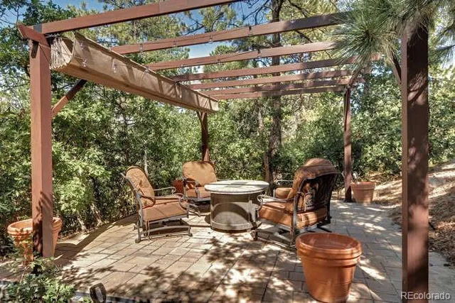 a building outdoor space with patio furniture and potted plants