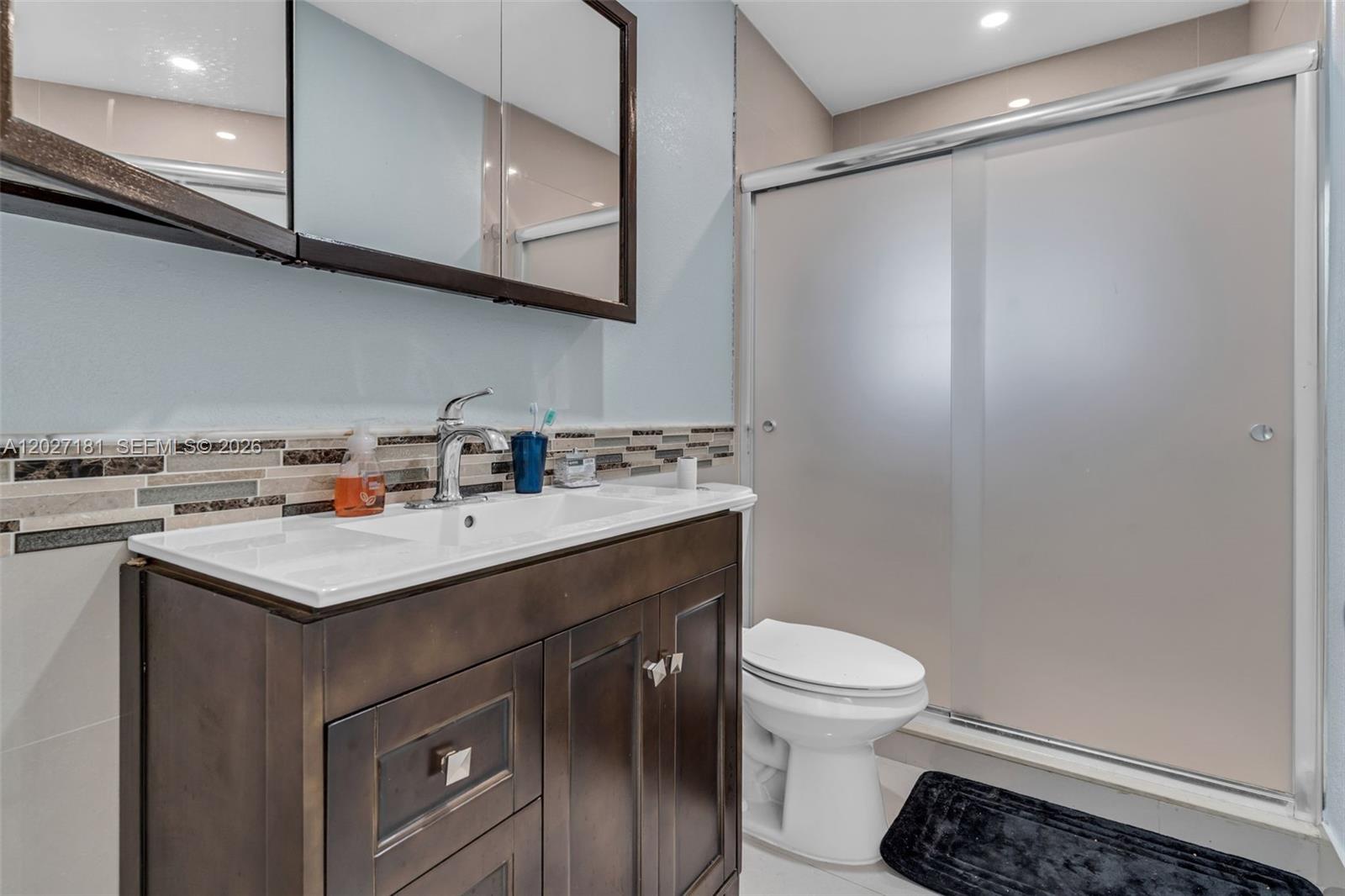 15440 Southwest 294th Terrace Homestead, FL 33033 - Photo 15 of 31 a bathroom with a sink a light fixture and a toilet