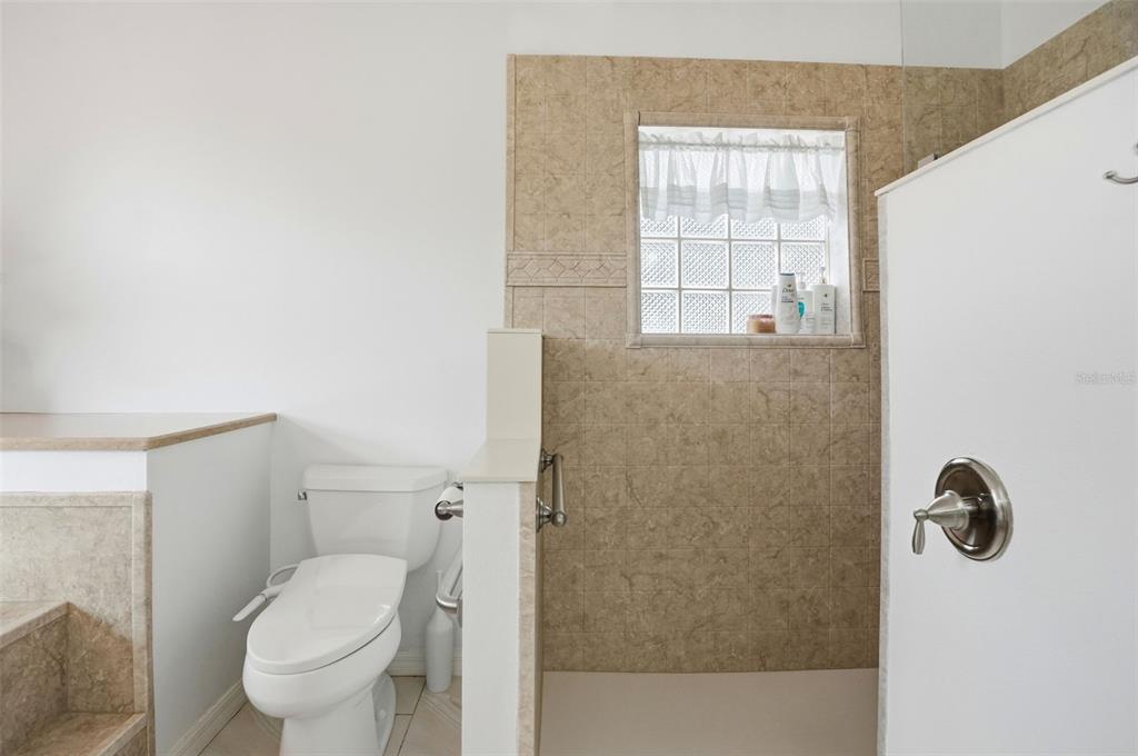 14228 Presteign Lane Spring Hill, FL 34609 - Photo 49 of 89 a bathroom with a toilet and a shower