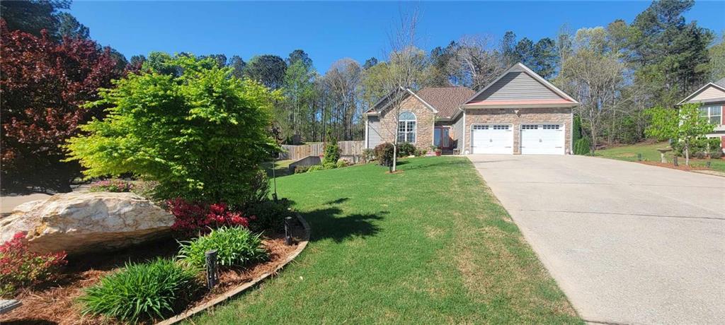 608 Muskogee Crossing Dallas, GA 30132 - Photo 1 of 1 a front view of a house with a yard