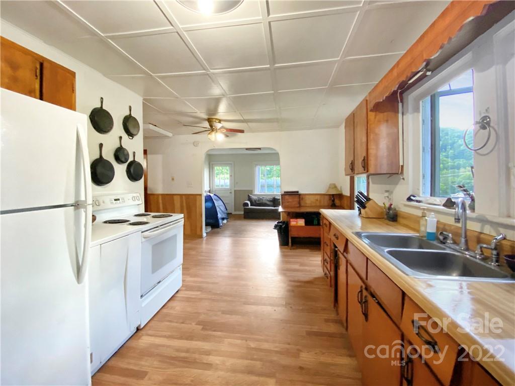 53 Saunook Road Waynesville, NC 28786 - Photo 3 of 10 a kitchen with stainless steel appliances a stove a sink a refrigerator and cabinets