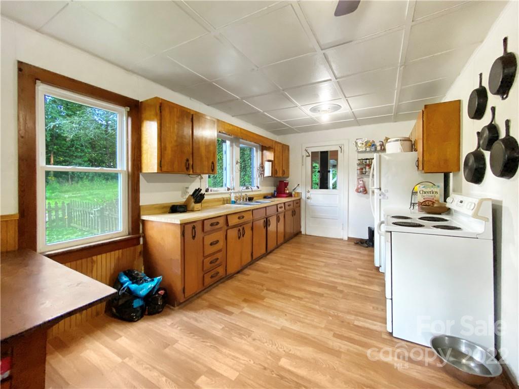 53 Saunook Road Waynesville, NC 28786 - Photo 4 of 10 a kitchen with stainless steel appliances kitchen island granite countertop a stove a sink and a refrigerator