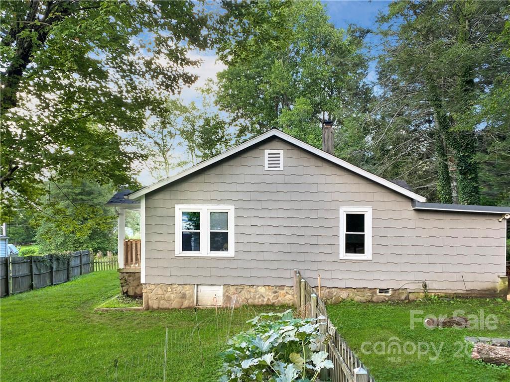 53 Saunook Road Waynesville, NC 28786 - Photo 10 of 10 a view of a backyard with plants and large tree