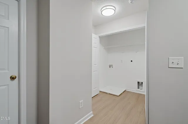 a view of a room with wooden floor