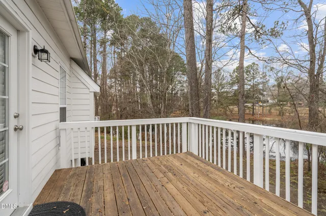 a view of balcony with wooden floor and fence