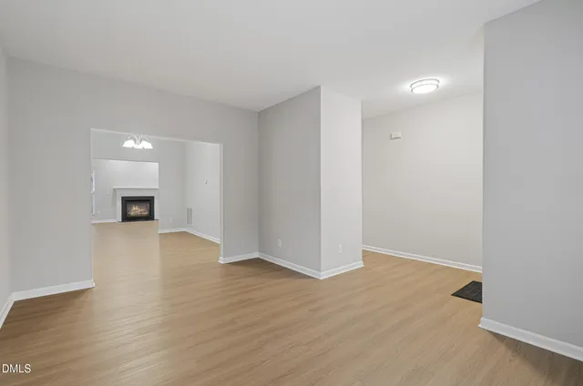 a view of a room with wooden floor and a window
