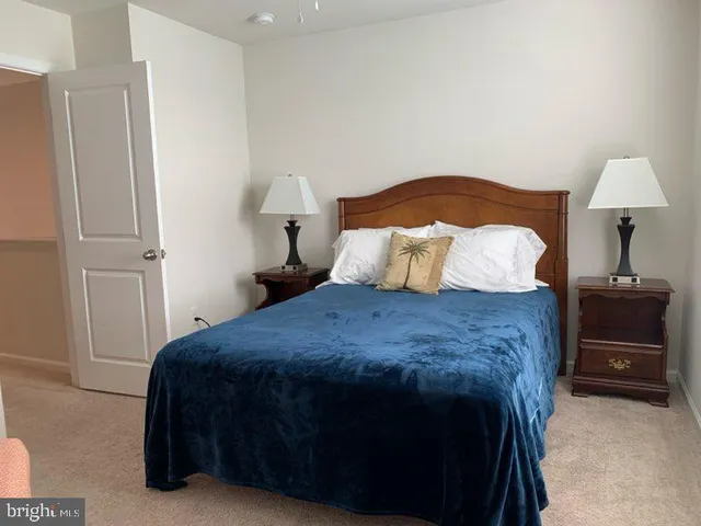 a bedroom with a bed and a lamp on table