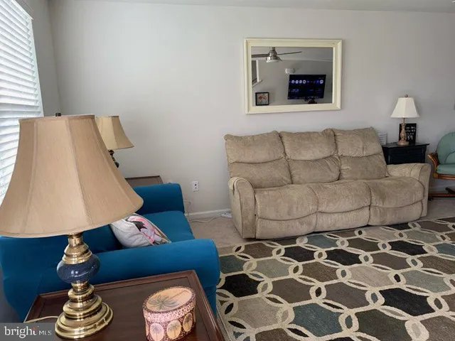 a living room with furniture and a lamp