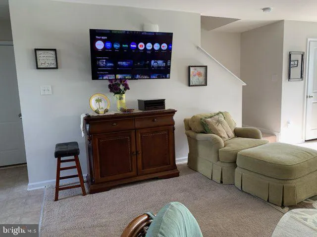 a living room with furniture a couch and a flat screen tv