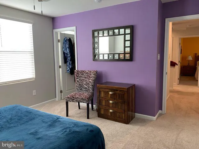 a bedroom with a bed and a chair