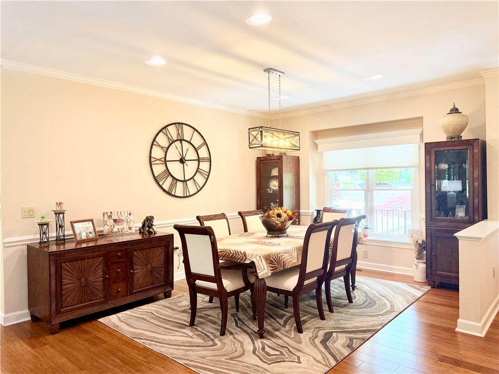 10 Captain Lane Salem, SC 29676 - Photo 11 of 28 This elegant dining room features rich wood flooring, crown molding, and abundant natural light.