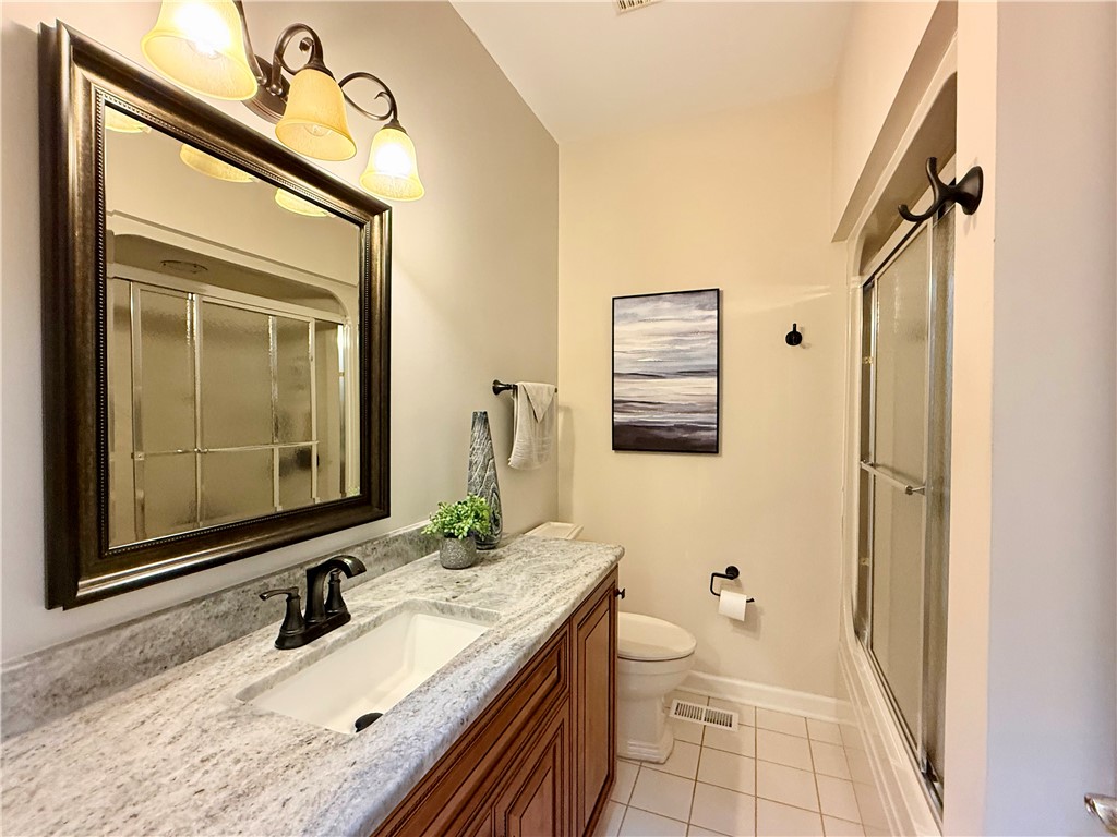10 Captain Lane Salem, SC 29676 - Photo 16 of 28 Enjoy the timeless appeal of this guest bathroom, right next to large guest bedroom, featuring a beautiful vanity, combo tub/shower, and classic tiled flooring.