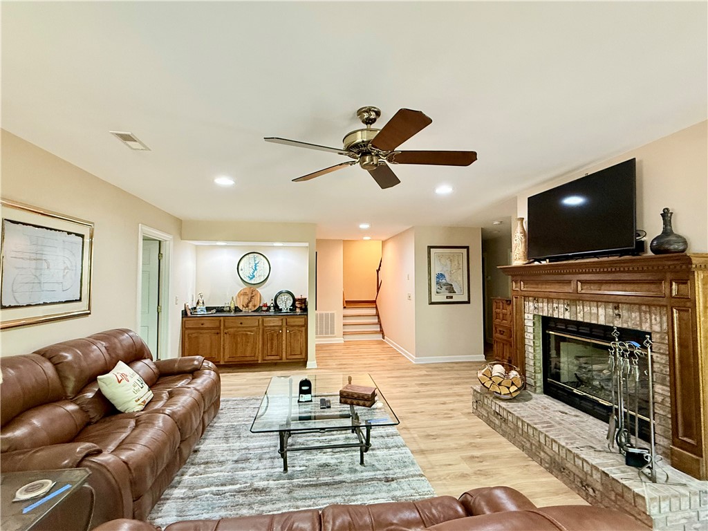 10 Captain Lane Salem, SC 29676 - Photo 19 of 28 This lower level living room features a classic fireplace and a well-appointed wet bar, creating an inviting space.