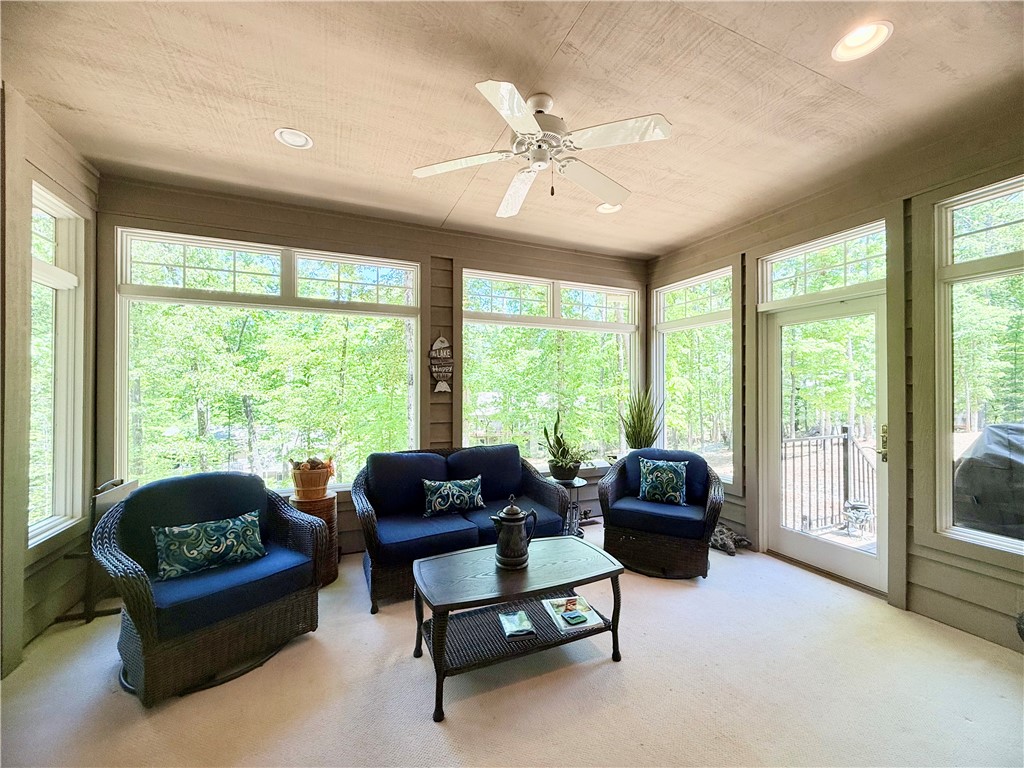 10 Captain Lane Salem, SC 29676 - Photo 7 of 28 Sun-drenched room with expansive windows offers serene views of lush greenery, and an electric fireplace with tv.
