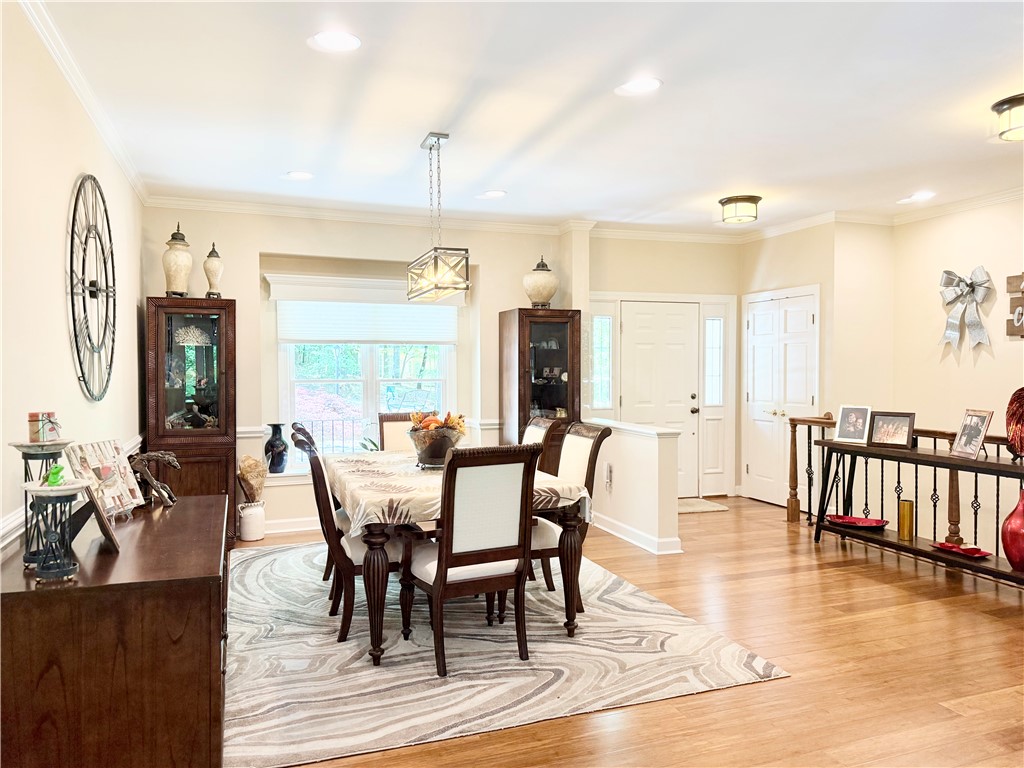 10 Captain Lane Salem, SC 29676 - Photo 10 of 28 This bright dining area features warm wood flooring and elegant crown molding, creating an inviting space.