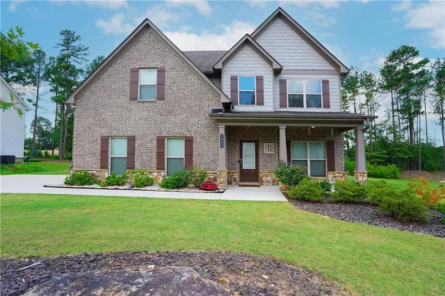 a front view of a house with a yard and porch