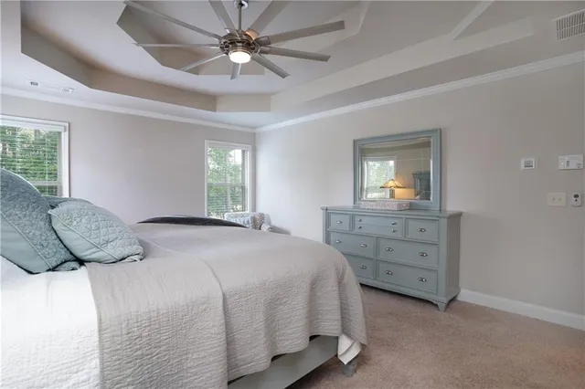 a bedroom with a large bed and a dresser