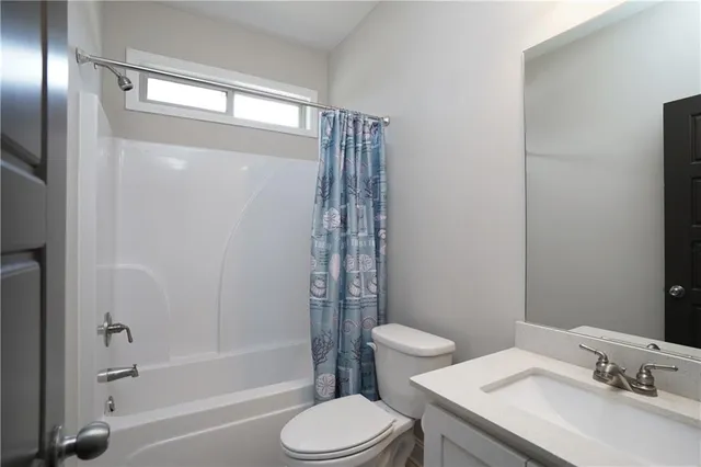 a view of a workspace with furniture and a ceiling fan