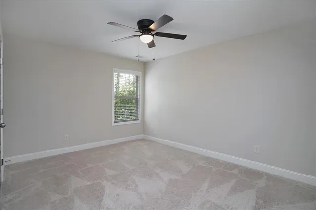 a white toilet sitting next to a shower