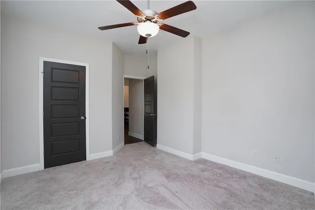 a view of house with a big yard and large trees