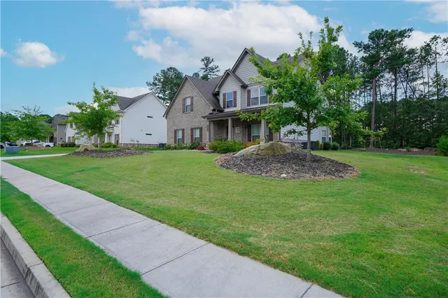 a front view of a house with garden