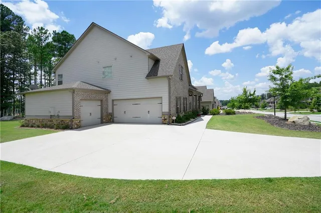 a front view of a house with a garden and yard