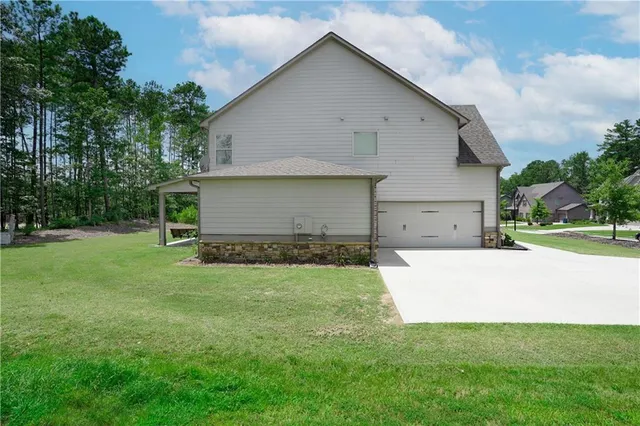 a view of a patio with a table chairs and a yard