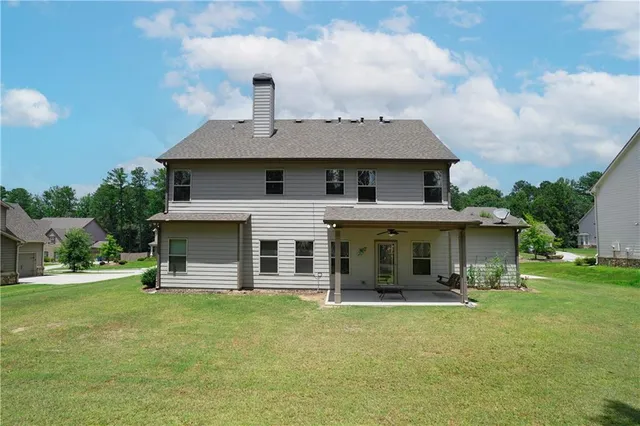 a building outdoor space with patio furniture and garden view