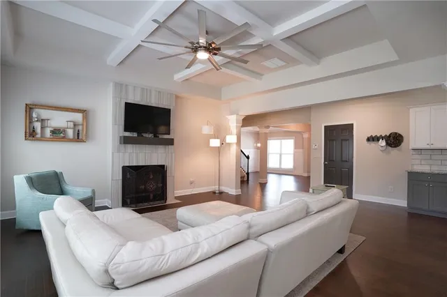 a living room with furniture a fireplace and a flat screen tv