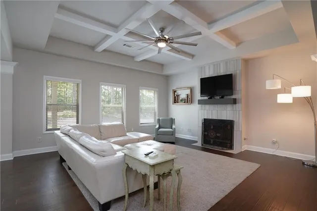 a living room with furniture a fireplace and a flat screen tv