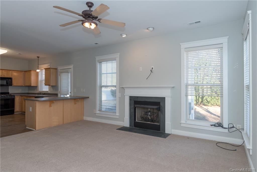 8319 Townley Road Huntersville, NC 28078 - Photo 12 of 17 a view of an empty room with kitchen and fireplace