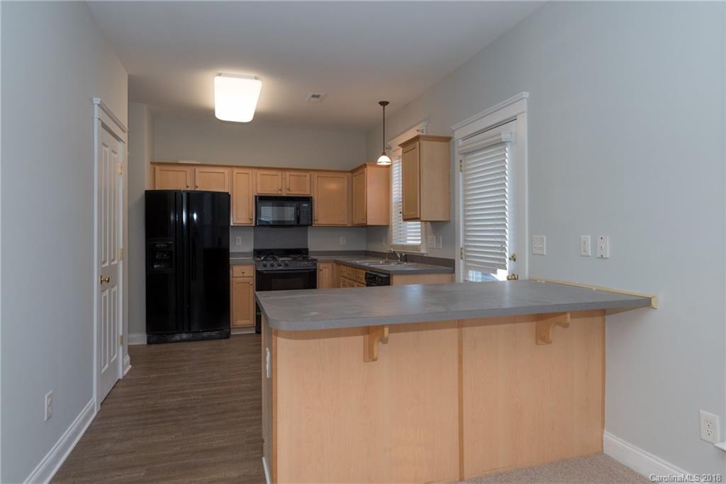 8319 Townley Road Huntersville, NC 28078 - Photo 8 of 17 a kitchen with stainless steel appliances granite countertop a sink and a refrigerator
