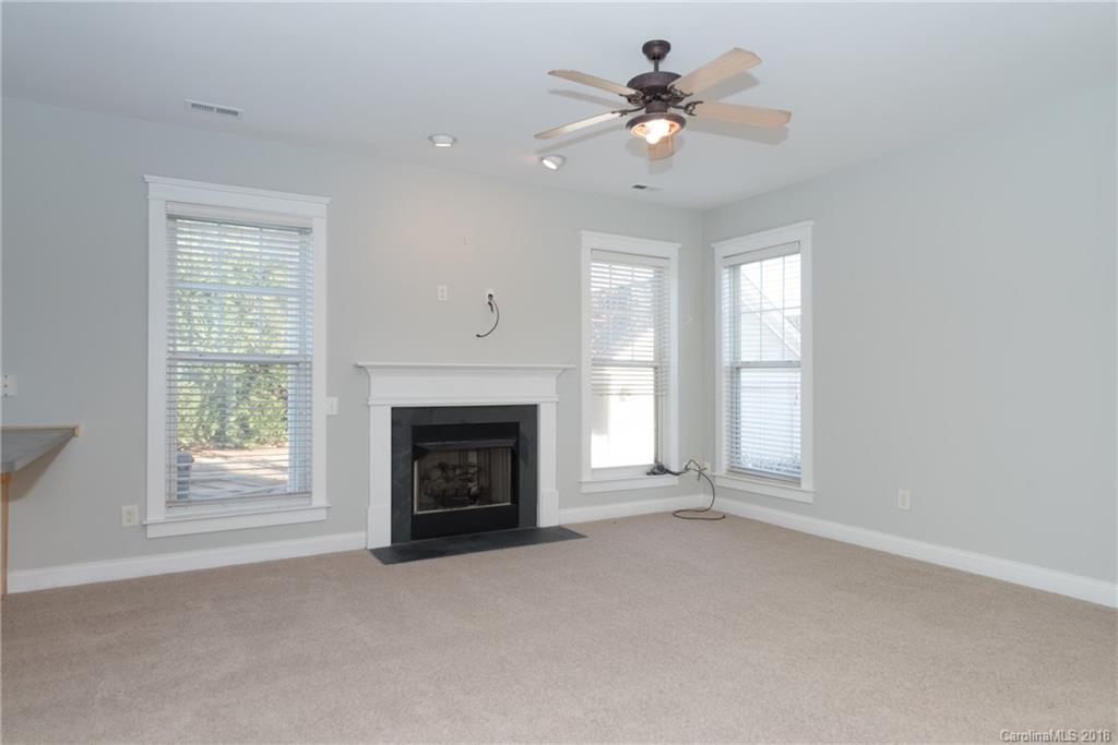 8319 Townley Road Huntersville, NC 28078 - Photo 10 of 17 an empty room with windows and fireplace